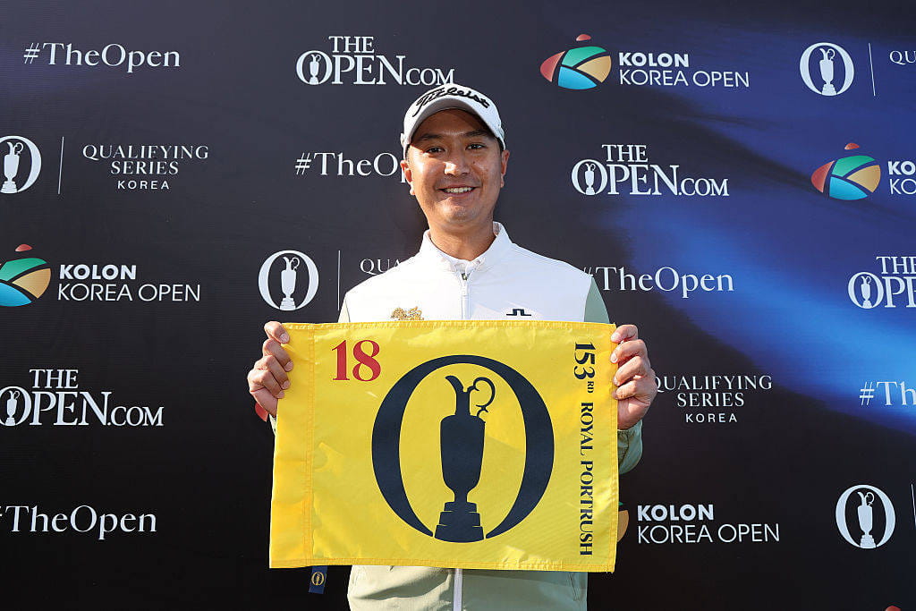 Sadom Kaewkanjana holds up a pin flag after qualifying for The 153rd Open via the Open Qualifying Series in Korea.